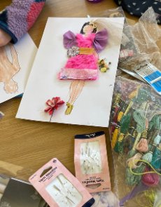 Fashion workshop with colour pages with models and materials to create fabric dresses with embroidery threat to decorate the figures.