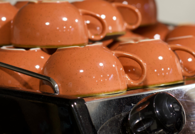 Orange cups on top of espresso machine
