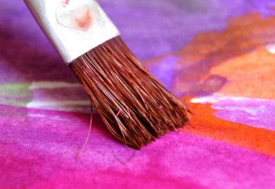 Paintbrush with neon pink and orange paint