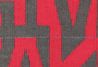 Lettering Tapestry 'GiveTake' by Caron Penney with grey and red lettering.