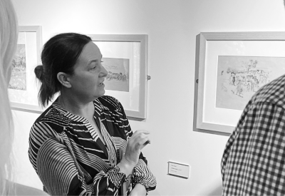 Louise Weller, Head of Collections and Exhibitions is leading a group of guests around the Petersfield Gallery.