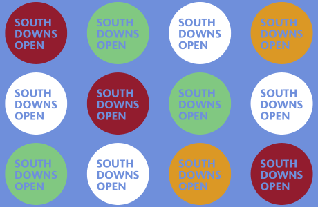 South Downs Open in yellow, red, green and white circles with blue background banner