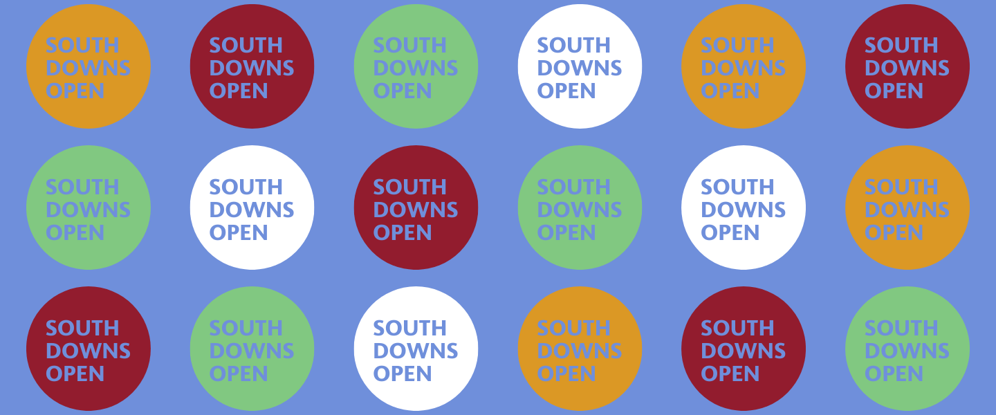 South Downs Open in yellow, red, green and white circles with blue background banner