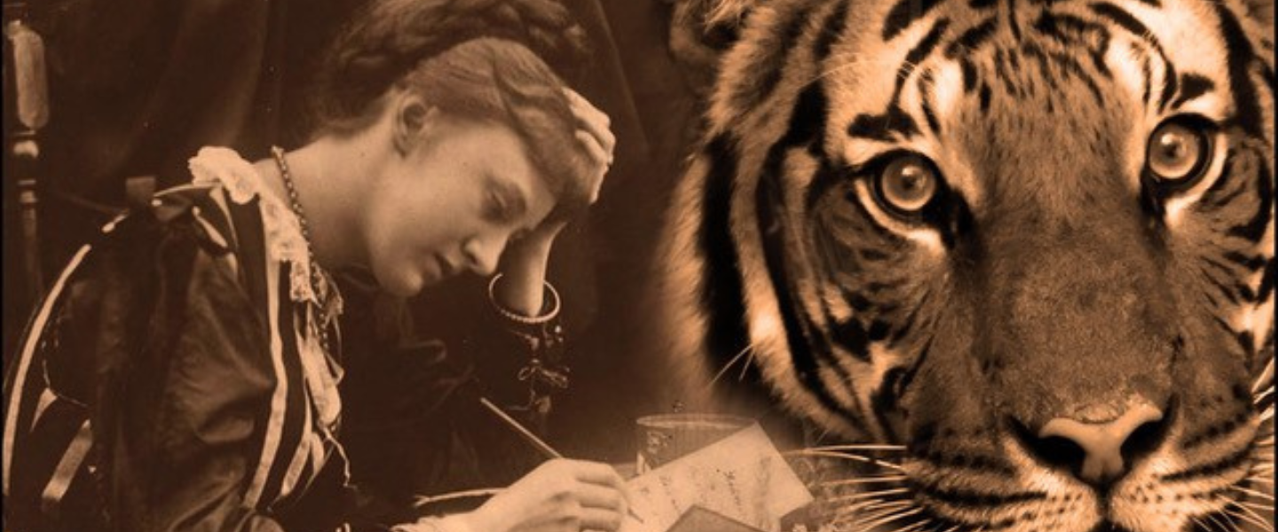 Woman writing at her desk and a tiger in front of her